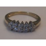 A 9ct gold diamond dress ring. Designed as a series of shared brilliant-cut diamond quatrefoils,