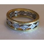 A 18CT Gold diamond full-circle eternity ring. Of bi-colour openwork design, the brilliant-cut