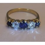 A mid 20th century 18ct gold sapphire and diamond five-stone ring. Size L. The circular-shape