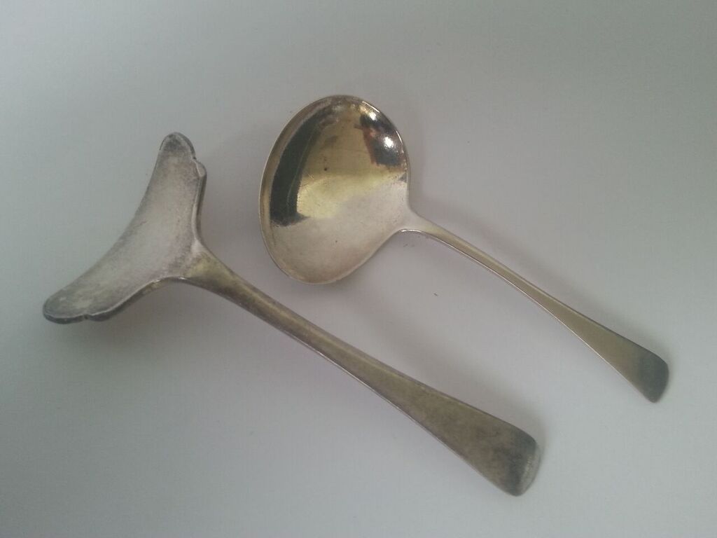 Silver baby spoon and pusher. The pusher hallmarked Sheffield 1920s made by Walker and Hall, the