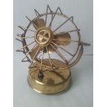 Brass battery operated desk fan standing at around 18cm high.