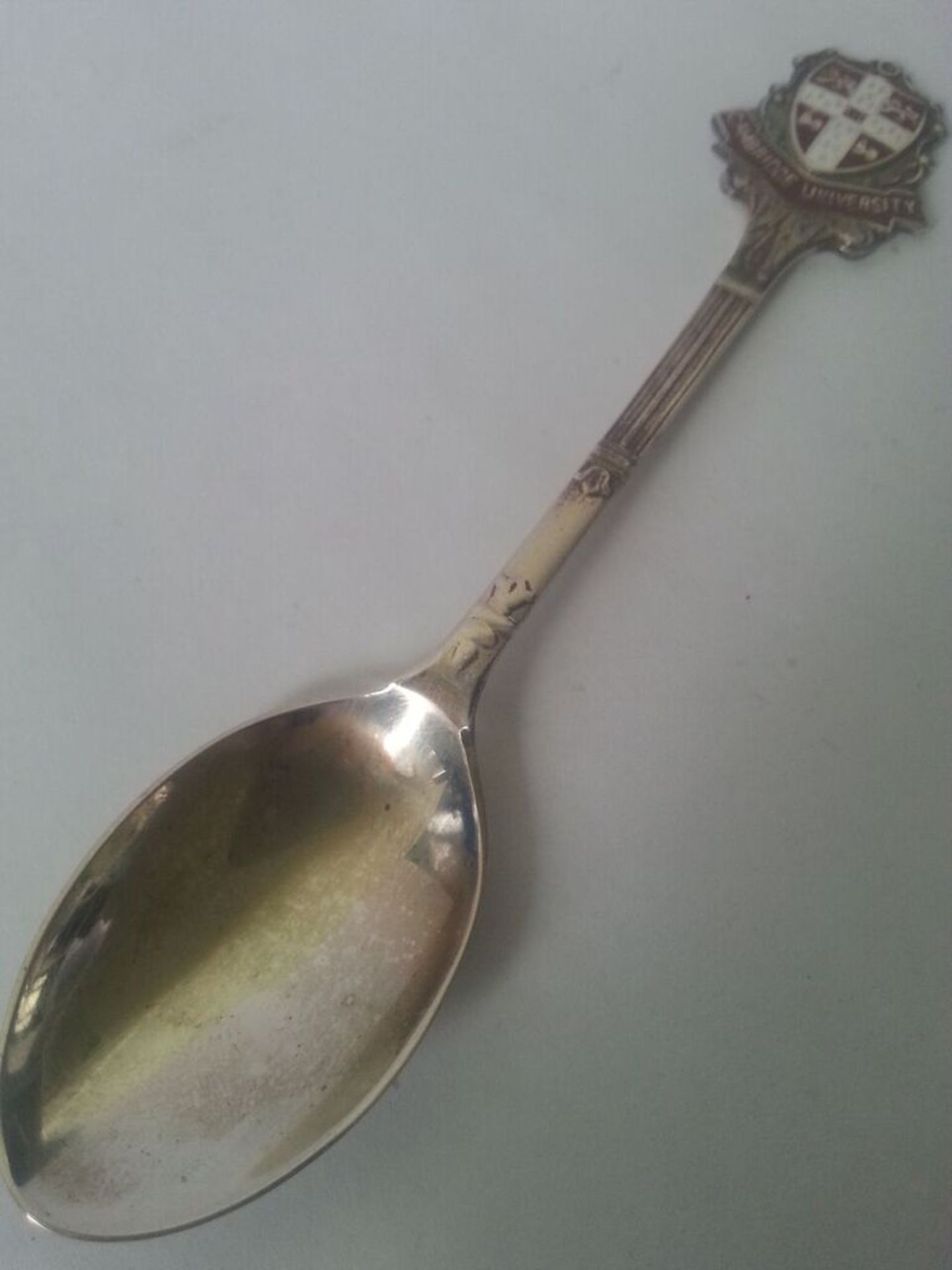Hallmarked Birmingham 1940s silver teaspoon with Cambridge University enamel badge. Makers marks