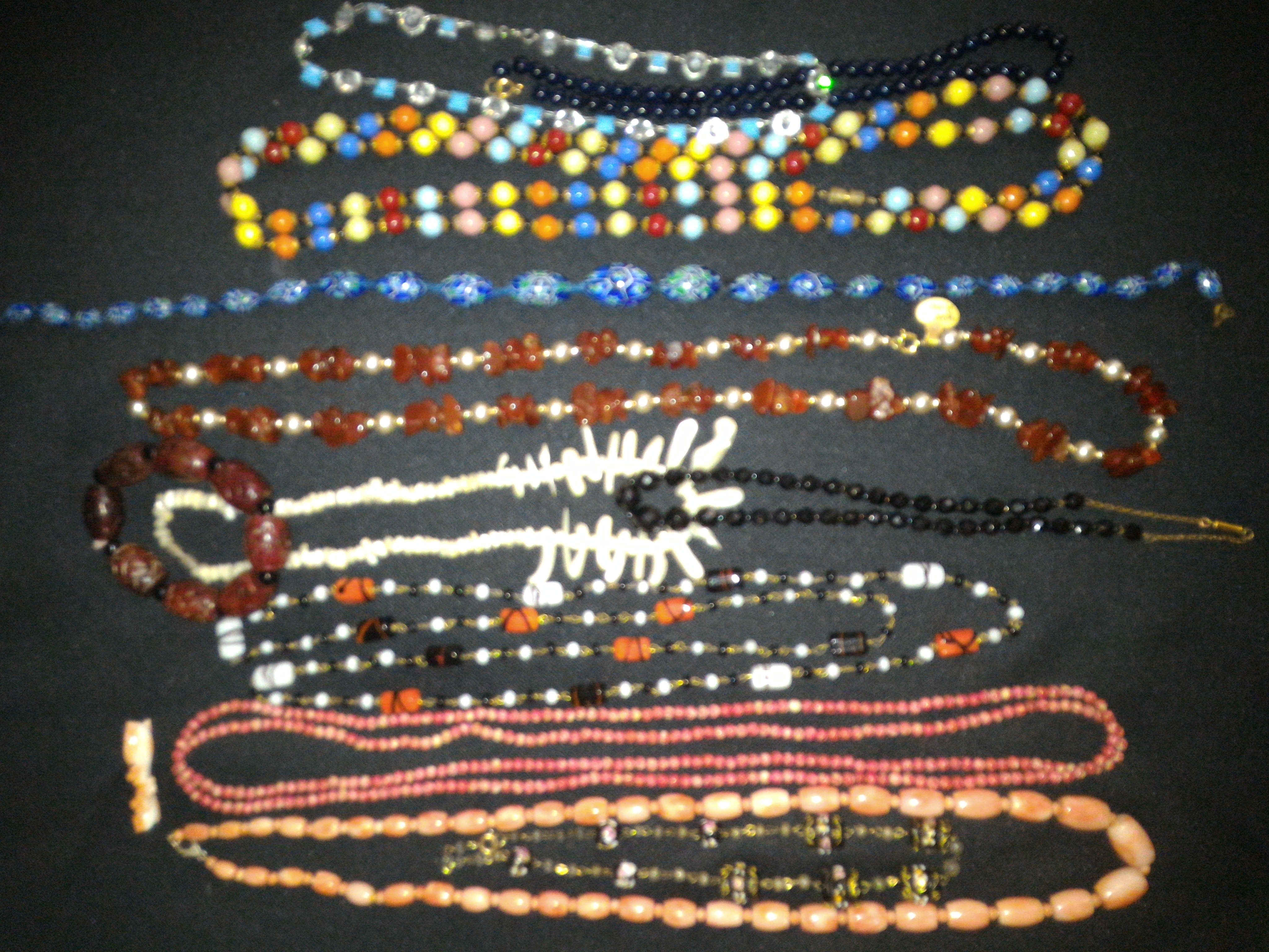 A collection of vintage beads necklaces and stone necklaces includes coral necklace