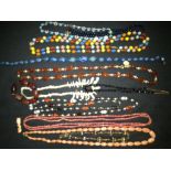 A collection of vintage beads necklaces and stone necklaces includes coral necklace