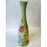 Tall Carlton Ware stem vase handpainted with rose decoration on a pale green ground. Gilt rim and