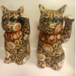 Pair of 20th century handpainted waving cats with signature or handpainted mark to base, 23cm