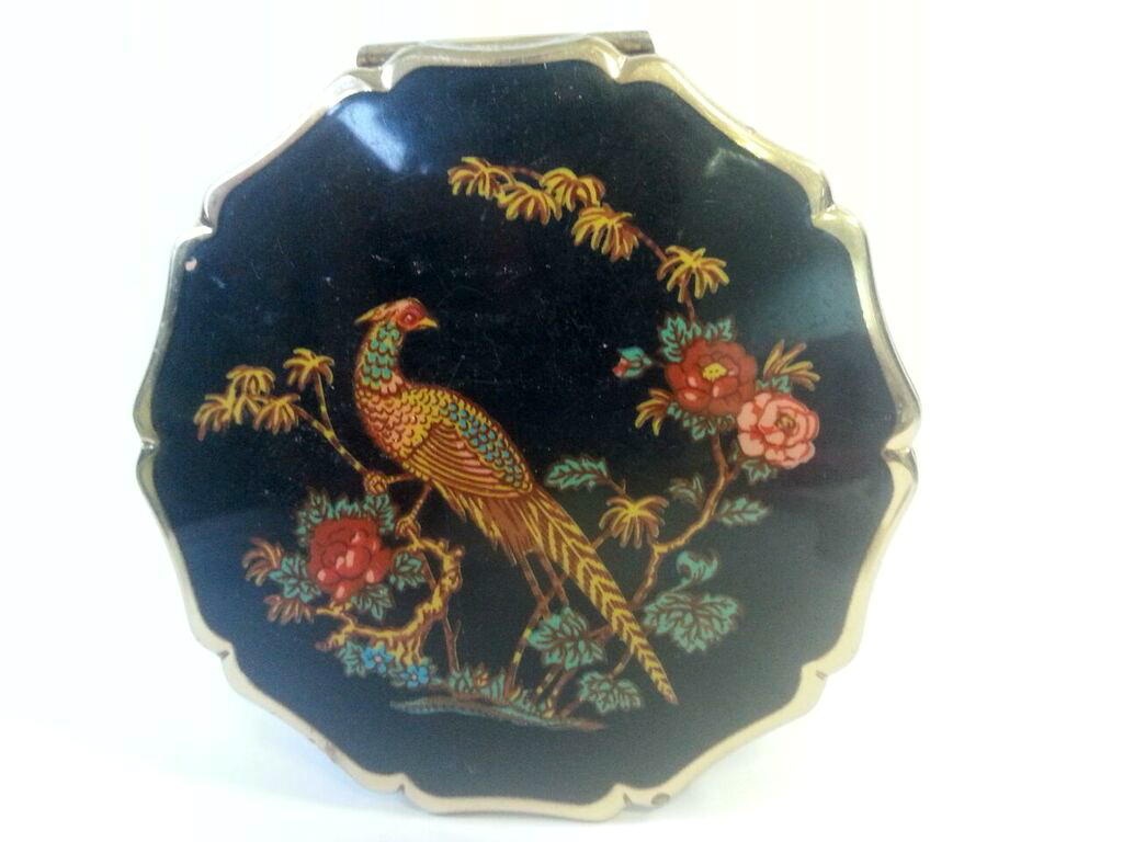 Vintage Stratton compact with Pheasant and floral decoration on black ground with scalloped edge.