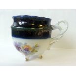 Fine antique porcelain cabinet cup having a rope twist handle & four feet, decorated with floral