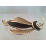 Vintage designer brooch with matte black and cream decoration. Signed HOLLYWOOD. Approx 7.5cm. Low