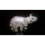 VINTAGE BROOCH IN THE FORM OF AN ELEPHANT WITH GREEN STONE EYE This is a beautiful vintage brooch in