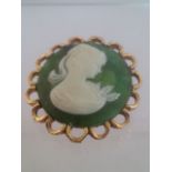 Vintage cameo brooch on a green background with gold tone border and setting. Approx 3.5cm. Low cost