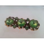 Stunning vintage bar brooch set with light green stones. Measures approx 4.5cm wide. Low cost