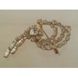 Stunning vintage crystal brooch set with round and baguette cut white stones in the form of a floral
