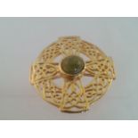 Celtic style gold tone brooch with central green agate type stone. Approx 3cm Low cost delivery