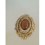 Vintage brooch set with white stones and a larger central amber coloured stone, approx 4.5cm at
