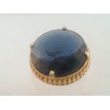 Large statement vintage brooch, large blue round cut stone set in a gold tone frame. Measures approx