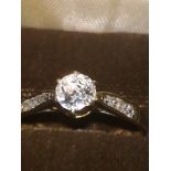 White gold diamond solitaire ring with diamond shoulders