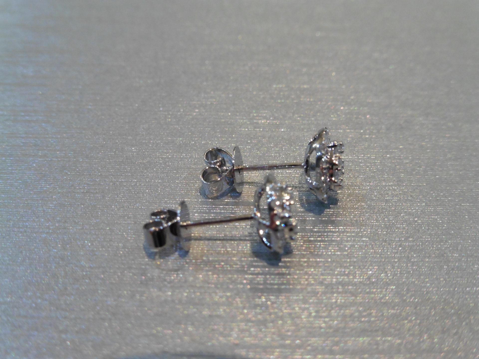 Brand new 14ct white gold diamond earrings. Each are illusion set with small brilliant cut - Image 2 of 3