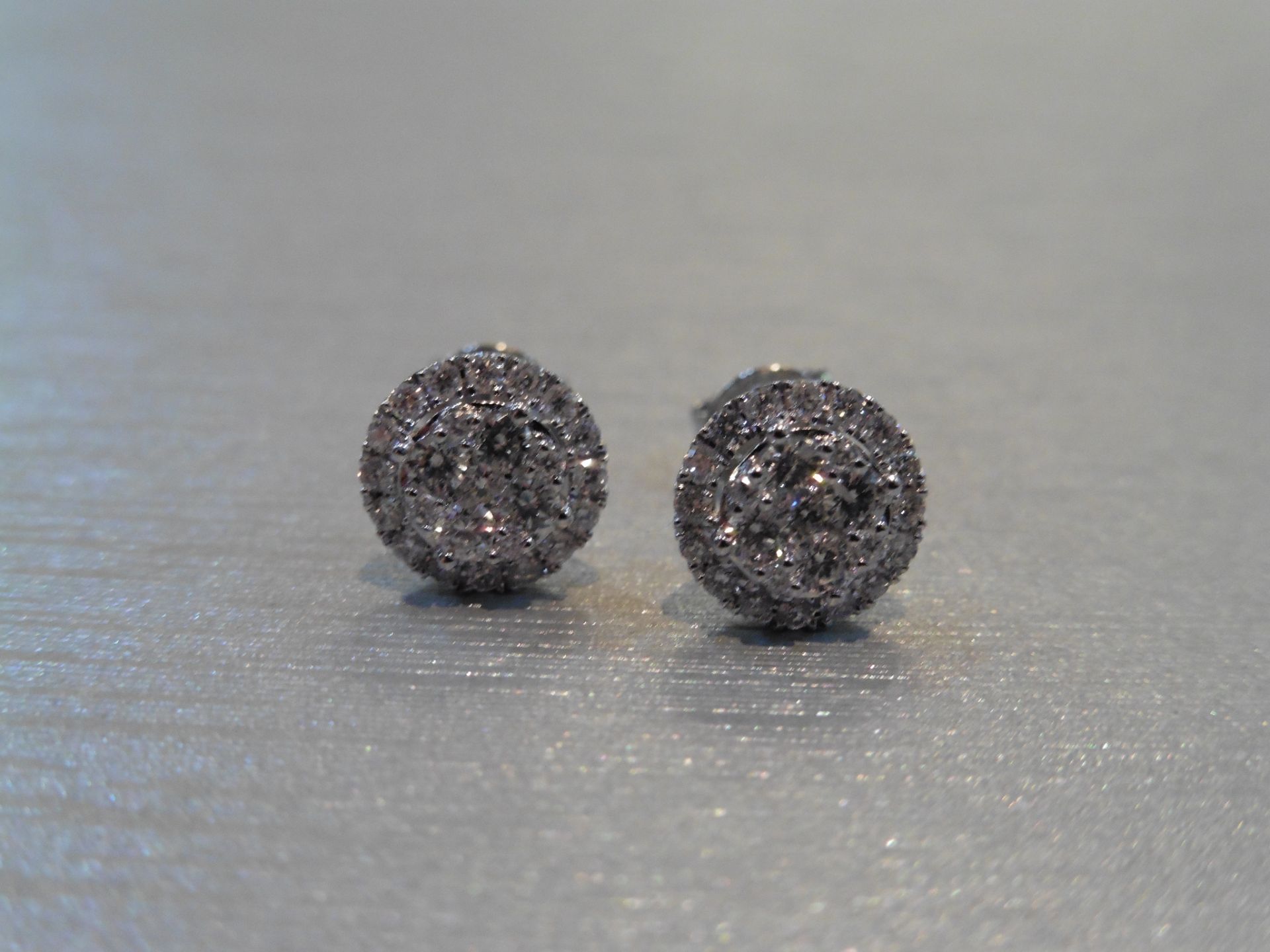Brand new 14ct white gold diamond earrings. Each are illusion set with small brilliant cut