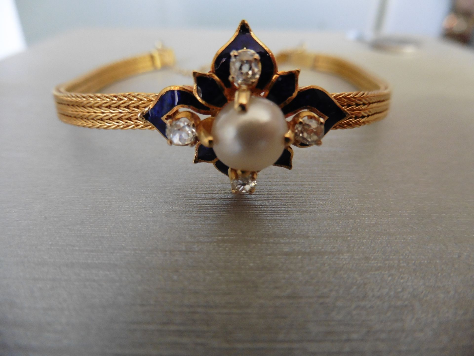Pre-owned 22ct gold antique pearl and diamond bracelet. Set with a 12.8mm white pearl in the