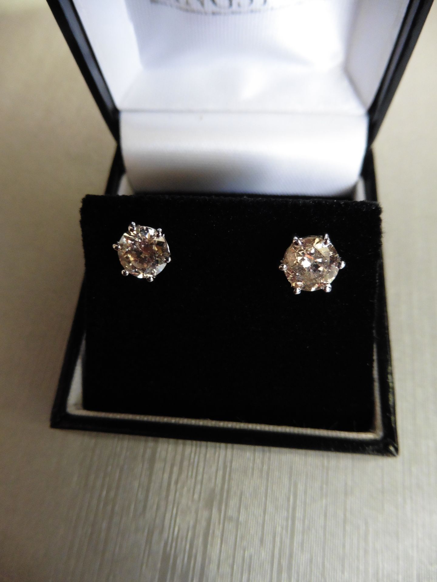 Brand new 18ct white gold diamond solitaire style earrings each set with a brilliant cut diamond.