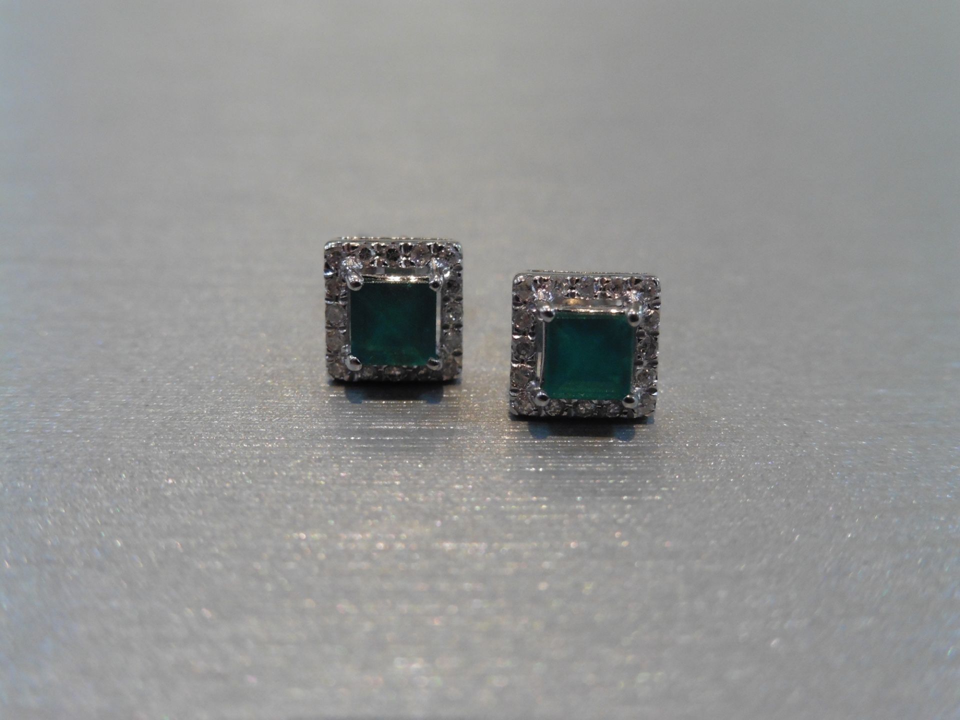 Brand new 9ct white gold emerald and diamond stud style earrings. Each set with a square cut emerald