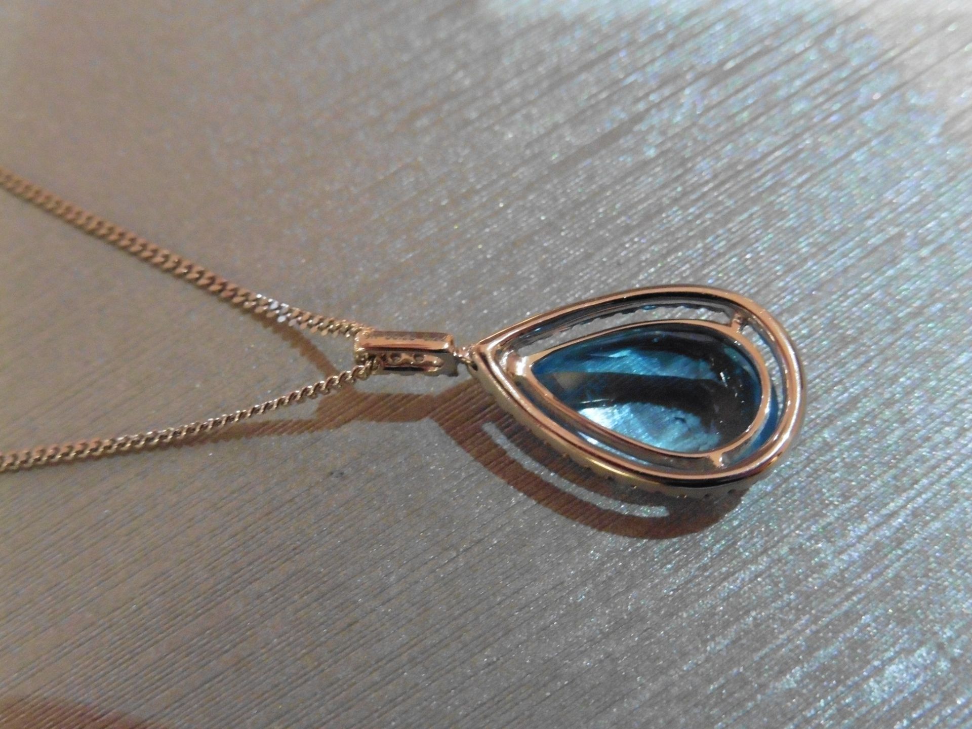 Brand new 9ct white gold blue topaz and diamond pendant. Set with a pear shaped blue topaz - Image 2 of 3