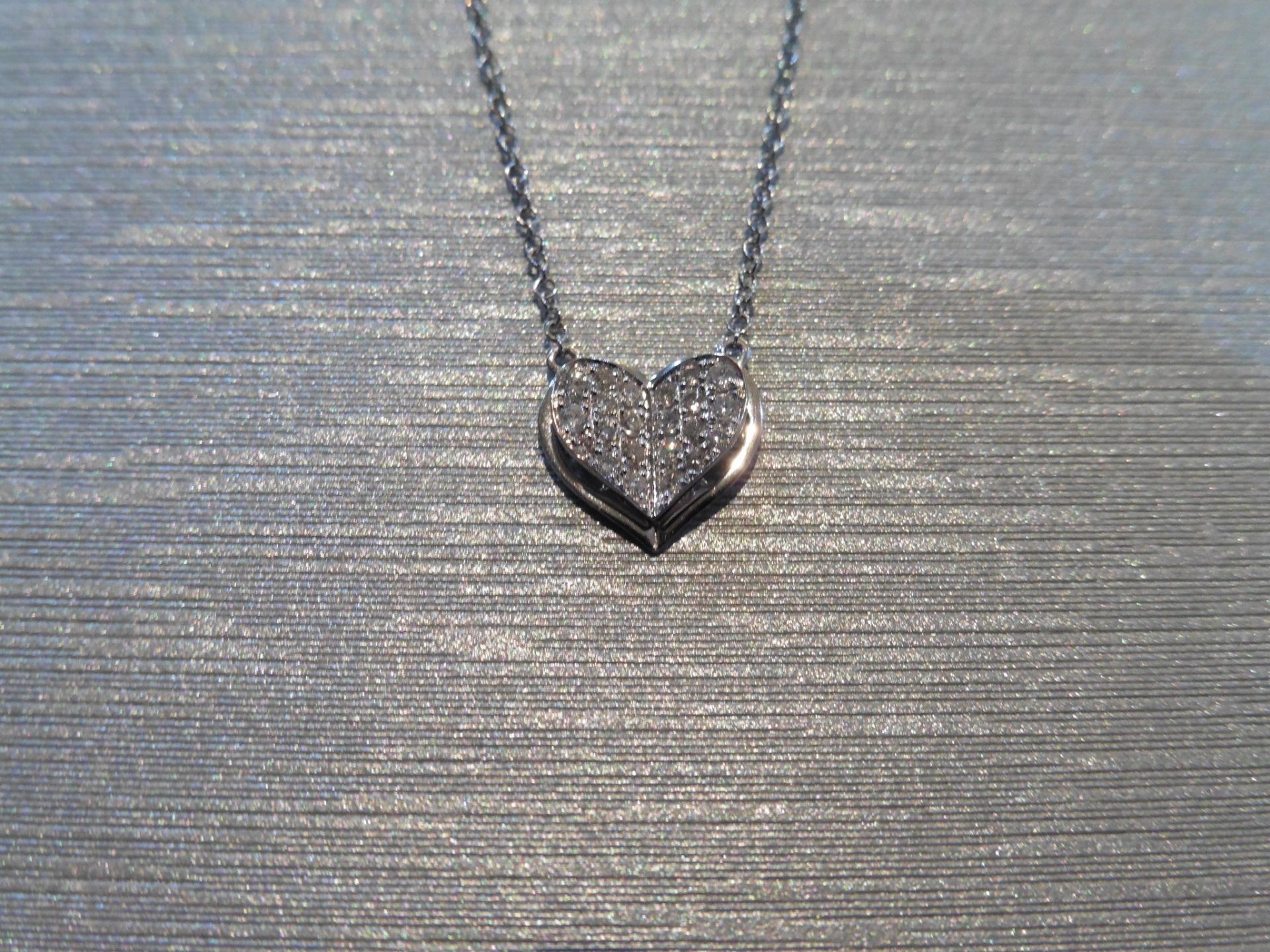 Brand new 18ct white gold diamond set heart pendant and chain. Micro set with tiny brilliant cut