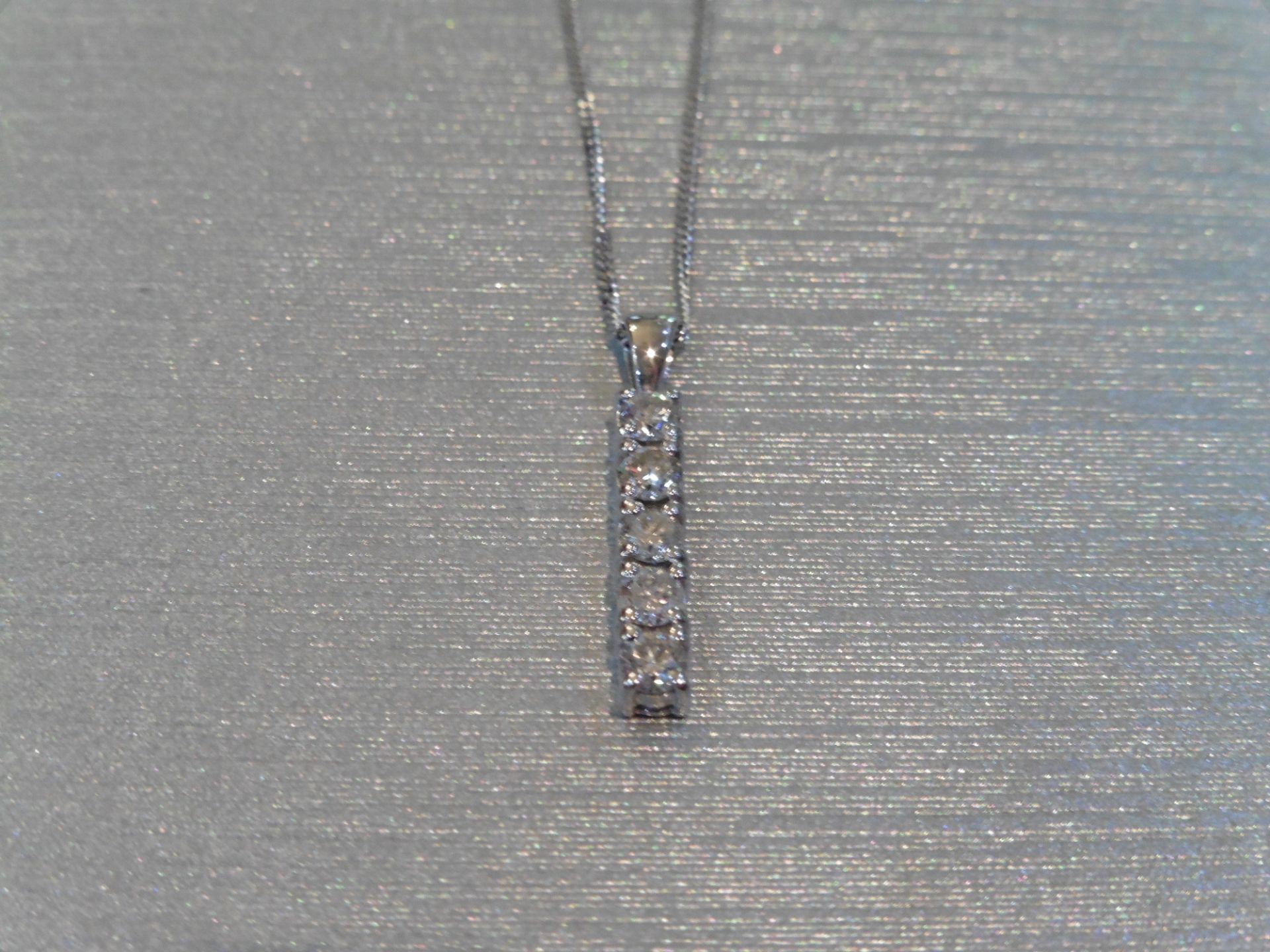 Brand new 18ct white gold five stone diamond drop pendant. Set with five brilliant cut diamonds, H