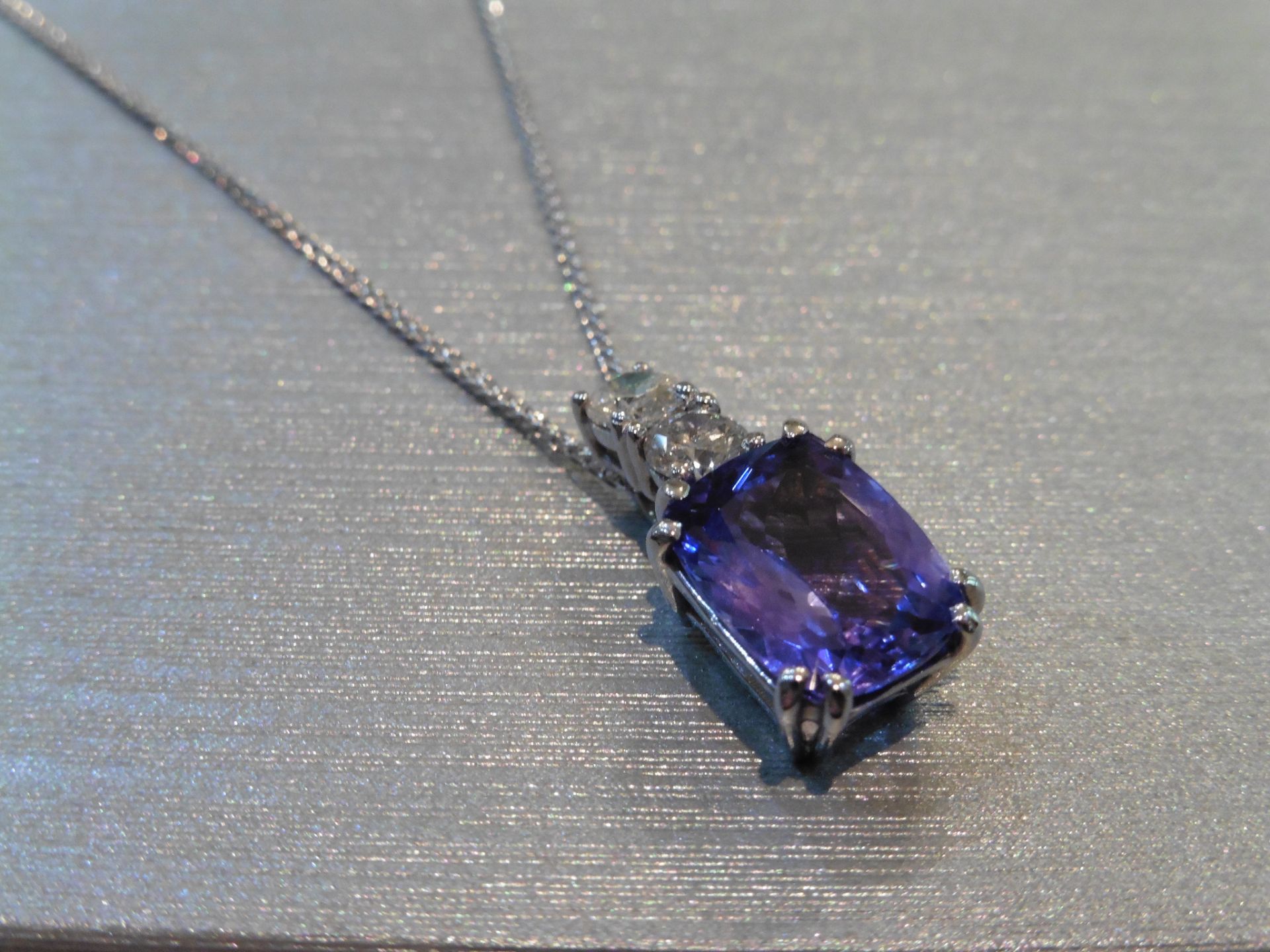 Brand new 18ct white gold Tanzanite and diamond pendant set with a 4.04ct emerald cut AAA