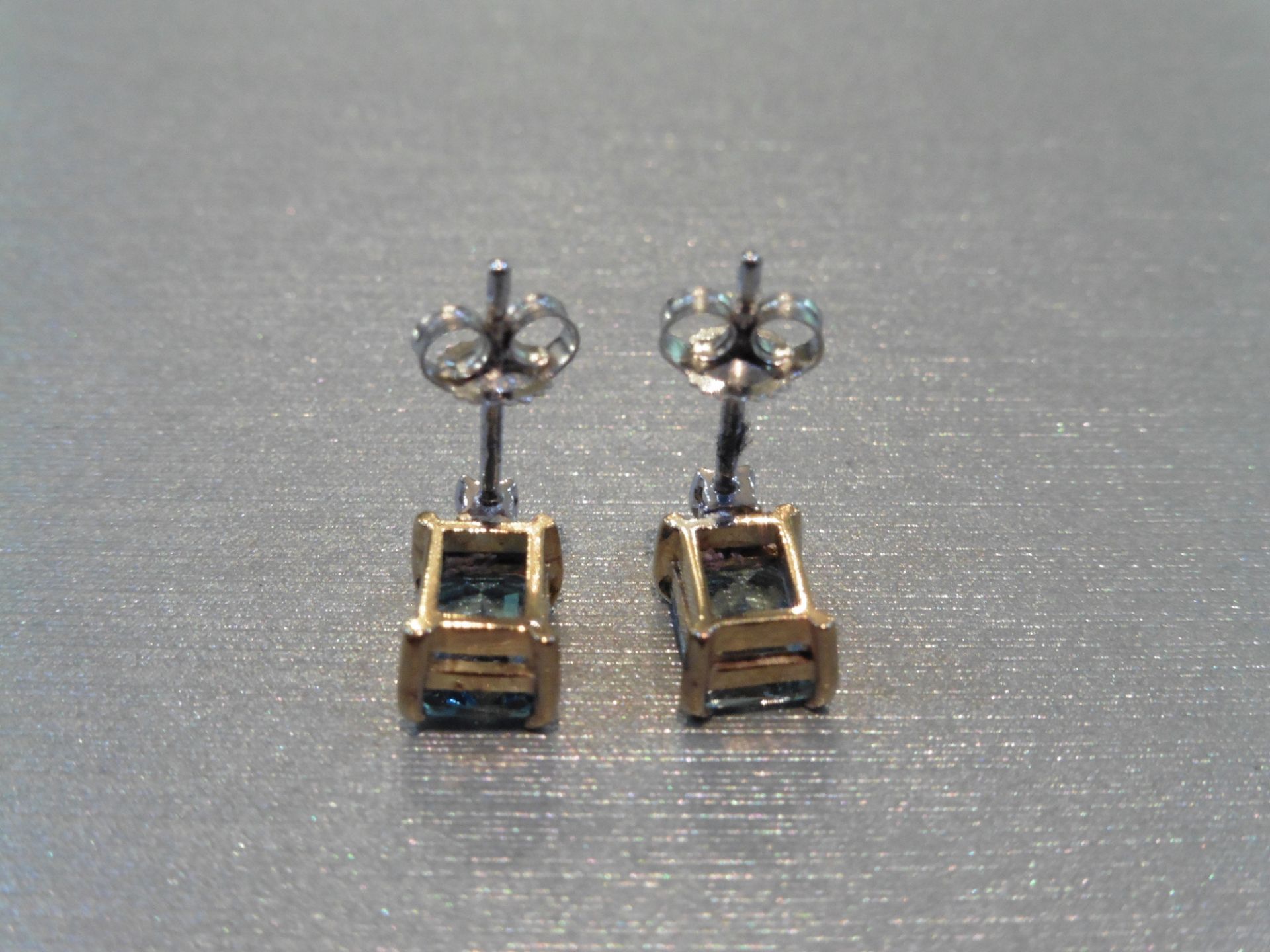 Brand new 9ct gold aqua marine and diamond earrings. Each set with an emerald cut aqua weighing 1. - Image 3 of 4