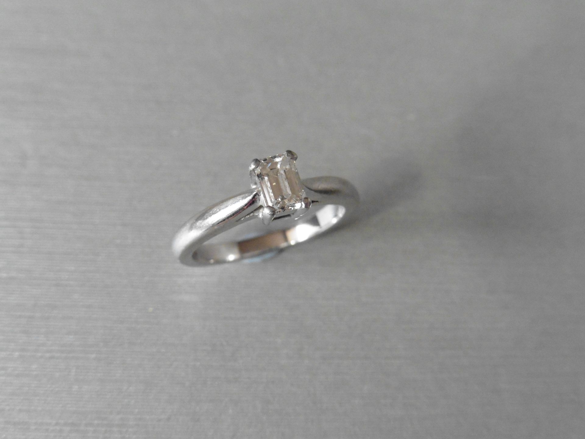 Pre-owned platinum solitaire with an emerald cut diamond of I colour and SI clarity, weighing 0.