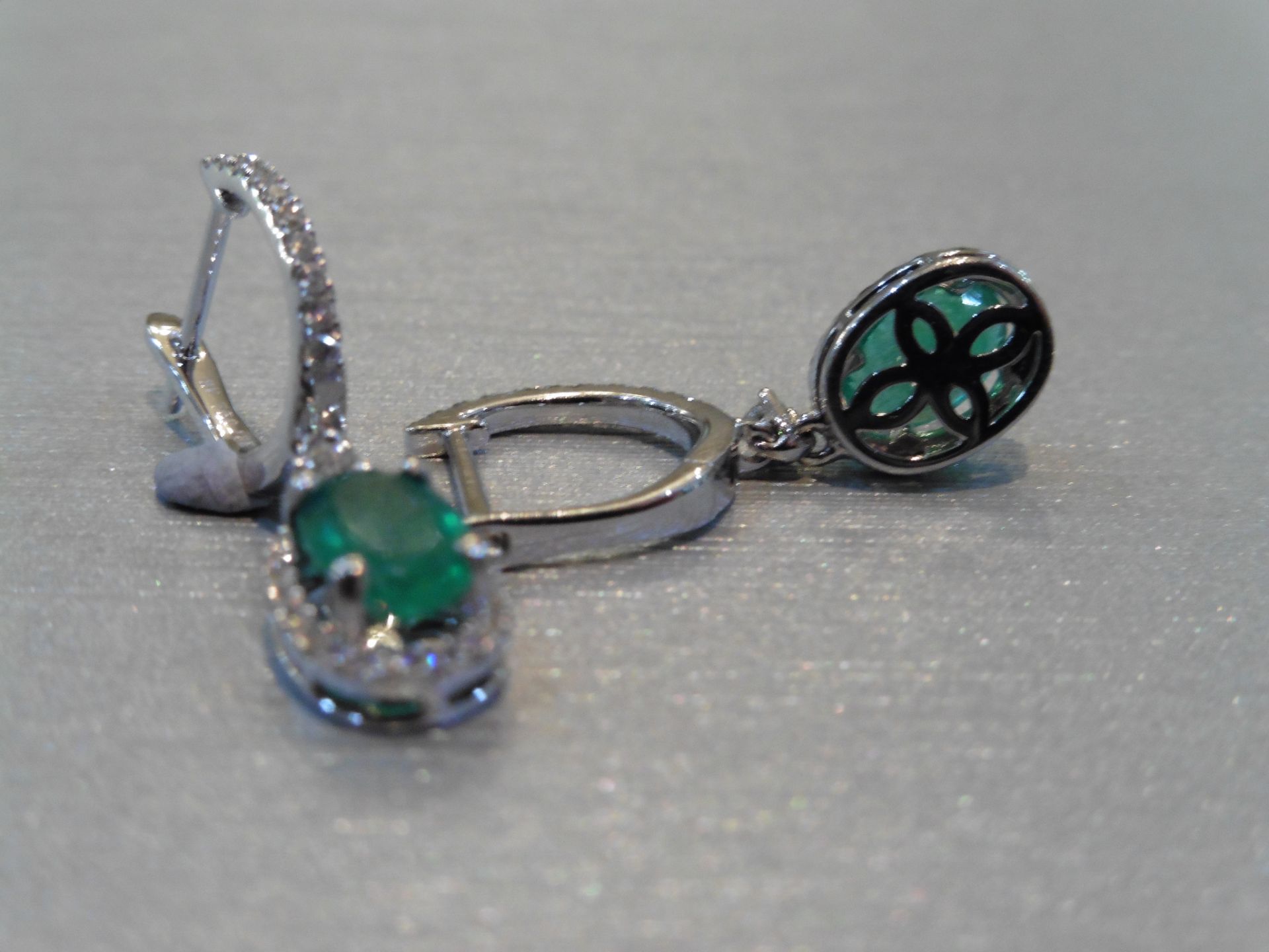 Brand new 18ct white gold emerald and diamond drop style earrings. Each set with an oval cut ( - Image 2 of 3