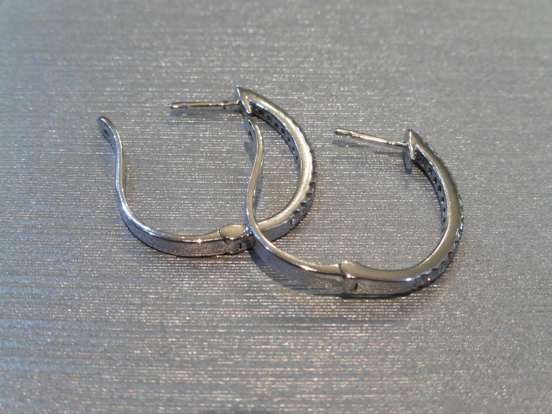 Brand new 18ct white gold diamond set hoop earrings. Set with small brilliant cut diamonds, weighing - Image 3 of 3