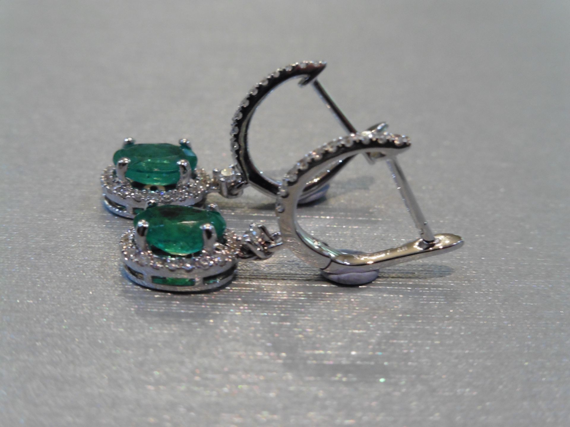 Brand new 18ct white gold emerald and diamond drop style earrings. Each set with an oval cut ( - Image 3 of 3