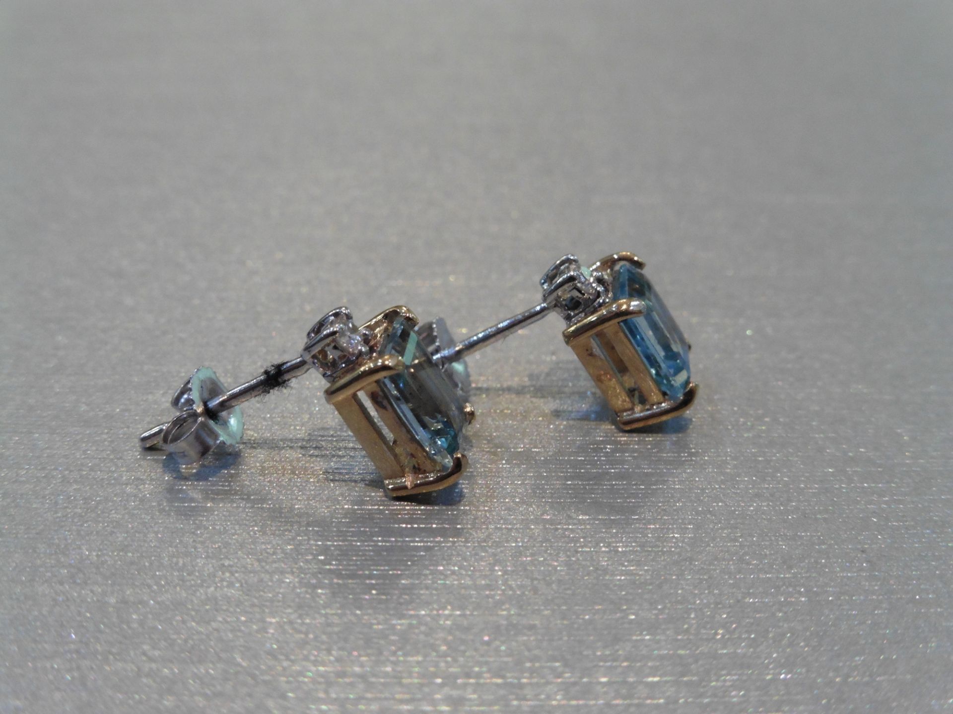 Brand new 9ct gold aqua marine and diamond earrings. Each set with an emerald cut aqua weighing 1. - Image 2 of 4