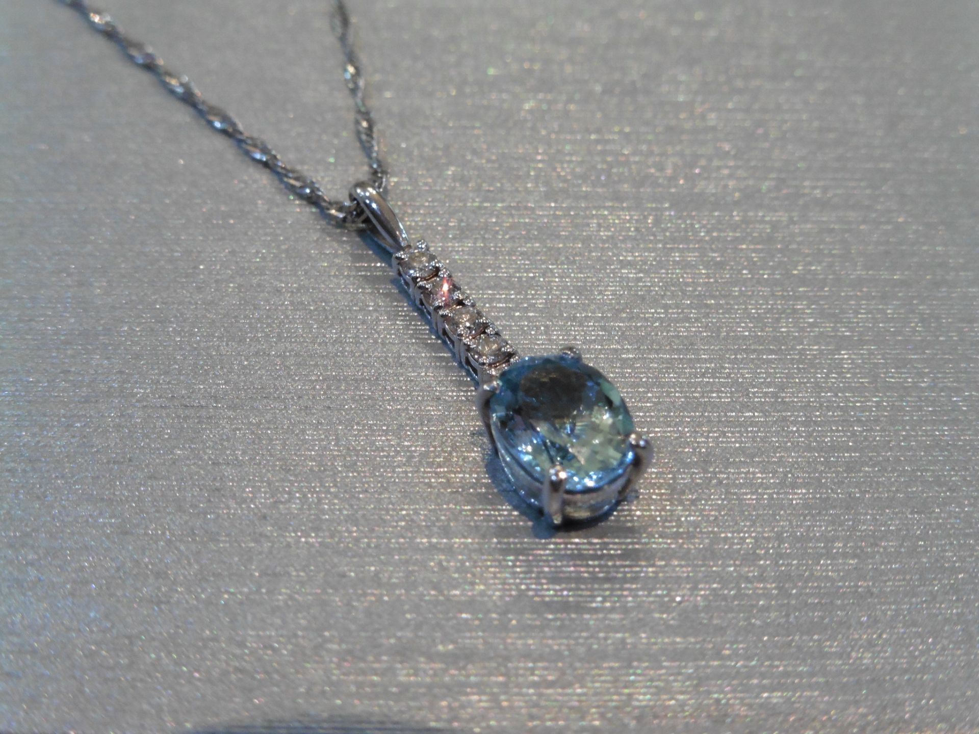Brand new 9ct White gold aqua marine and diamond drop style pendant set with a 1.50ct oval cut