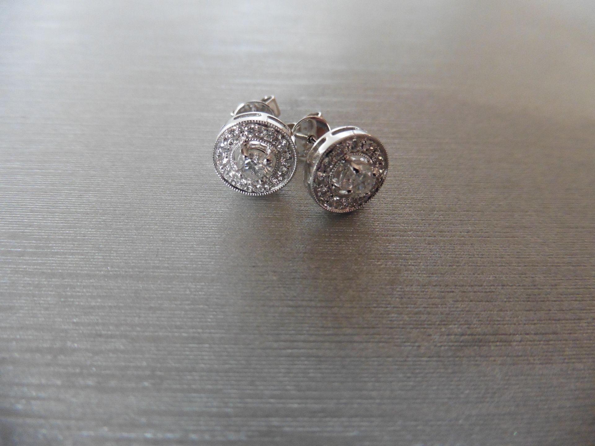 Brand new pair of 18ct white gold diamond set earrings each set with a 0.30ct brilliant cut