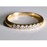 A 9 ct gold diamond ring, A line set half eternity ring set with well matched diamonds. 0.25CTS -