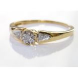 A 9ct gold diamond ring. A single diamond, with two further diamonds on each shoulder. 1.5 grm -