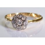 An 18ct gold diamond floral cluster ring. 2.3 grms - size M.