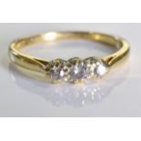 An 18ct gold & Diamond trology ring. Three brilliant cut diamonds set in 18ct gold. 2.7grms - Size