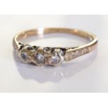 A mid 20th century 18ct gold trilogy ring. 3 illusion set diamond ring within an ornate setting of