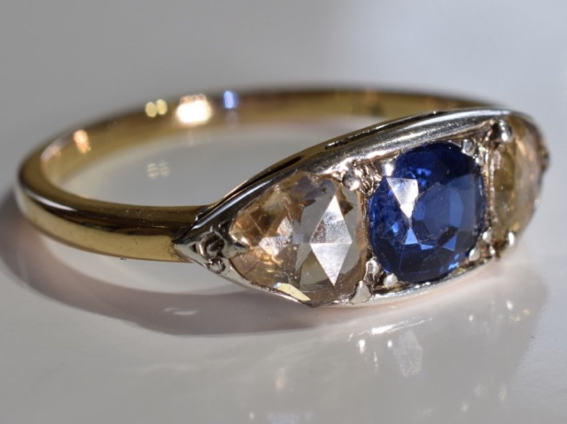 A sapphire and diamond three-stone ring. Size L - The circular-shape sapphire, with triangular-shape - Image 3 of 3