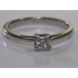 A platinum diamond ring with a square-shape diamond Estimated total diamond weight 0.30ct, principal