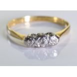 An 18ct gold and diamond trilogy ring, three brilliant cut diamonds set in 18 gold and platinum. 2.