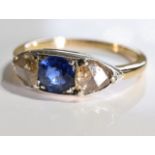 A sapphire and diamond three-stone ring. Size L - The circular-shape sapphire, with triangular-shape