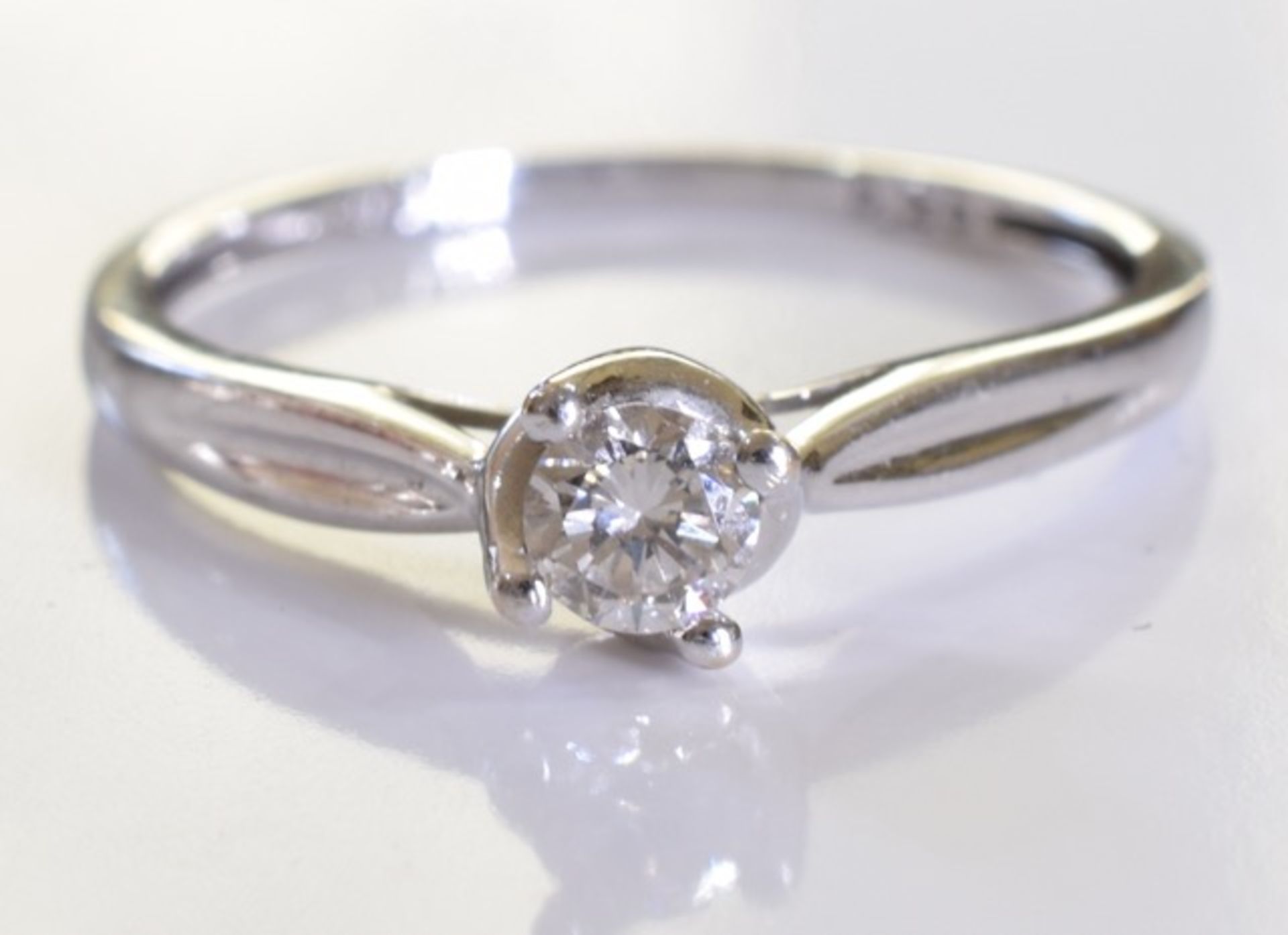 A brilliant cut single round diamond ring set in 9ct white gold.