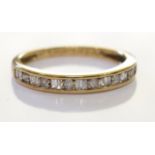 A 9ct gold diamond ring. Set with round brilliant cut diamonds along sige baguette cut diamonds,