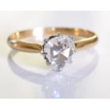 A diamond single-stone ring. The rose-cut diamond, to the tapered shoulders and plain band. Ring